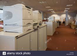 Printers And Fax Machines Set Up On Top Of Cupboards In An
