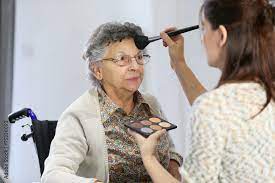 home carer helping elderly woman to put