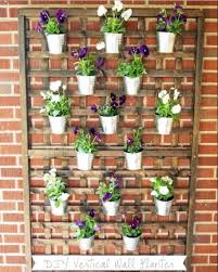 An outdoor garden with hanging buckets. 35 Cool Diy Wall Planter Ideas For Vertical Gardens The Self Sufficient Living