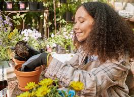 Black Woman At Work With A Potted Plant