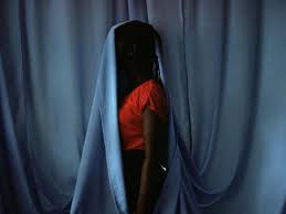 Woman hiding behind curtain