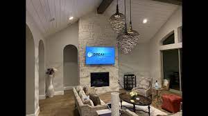 q7f 4k tv over stone fireplace