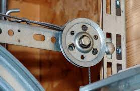 Reposition the stepladder at the outer end of the upper section of the track near the door. Extension Spring Pulley Replacement