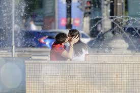 young couple kissing free stock photo