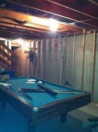 Unfinished Basement With A Pool Table
