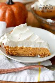 a rich and creamy baked pumpkin cheesecake with warm fall es and a creamy whipped topping