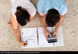 High Angle View Of Couple Calculating Budget Stock Photo