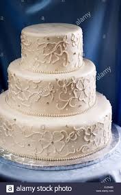 Three Tiered Wedding Cake Covered In Ivory Fondant With