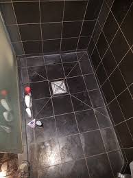 black limestone shower cleaning and