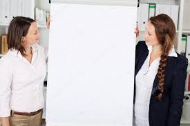 Businesswomen Giving A Flip Chart Presentation Stock Photo