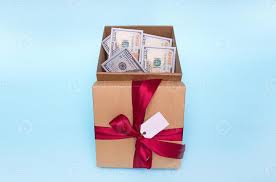 gift box filled with money next to it