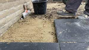 A Worker Laying Paving Slabs On The