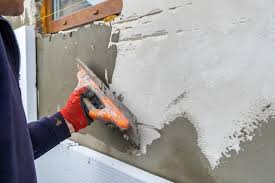 Construction Worker Covering House Wall