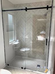 A frameless shower enclosure uses sturdy tempered glass (usually 3/8 to 1/2 thick) that does not require the support of metal around its exterior edges. Barn Doors Vs Swinging Doors Image Glassworks