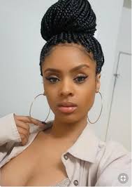 Before starting any hairstyle, make sure that your hair is nicely moisturized. Black Woman With Dark Box Braided Hair In A Top Knot Douglas J