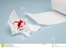 A Photo Of Used Bloody Toilet Paper And A Tiolet Paper Roll