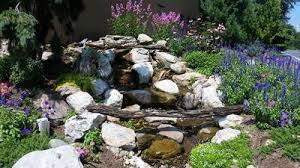 The aquablox structure of the pondless waterfall makes the feature sturdy enough for animals and people to step. Spring Water Feature Maintenance Pondless Waterfall Dreamscapeswatergardens Com