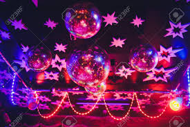 Beautiful Shiny Balls With Colorful Lights On Ceiling In Night