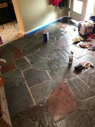 dirty slate floor with crumbling grout
