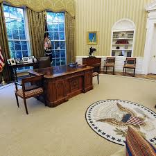 The desk is featured in the iconic photograph of a young john john kennedy poking is head through the secret door in front of the desk. President Obama S Oval Office Remodel