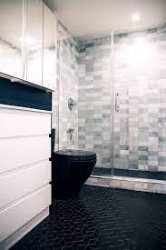 marble tile bathroom with black walls