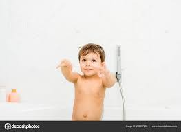 small cute boy gesturing white bathroom