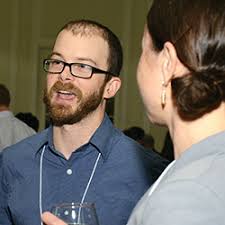 Chris Hakkenberg, left, the Kevin Satisky and Judith Thorn Summer Research Fellow, speaks with Suzanne Buchta. - Chris