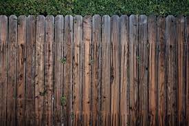 wood fence with a pressure washer
