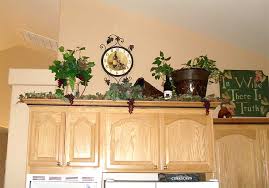 Have you ever wondered what to do with that awkward space above your kitchen cabinets? How To Decor Decorating Above Kitchen Cabinets Home Decor Designs Decorating Above Kitchen Cabinets
