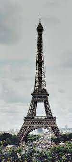 266785 the eiffel tower on a cloudy day ...