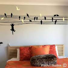 cat chasing birds on a wire wall decal