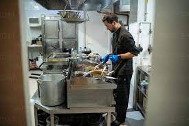 man cooking while standing at