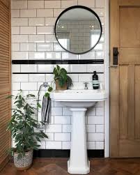 Bathroom With White Tiles And Black Grout