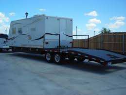 truck camper on a flatbed trailer