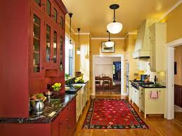 Navy is a good color to use when color blocking in the kitchen, and it pairs well with bright yellow, magenta and turquoise. Galley Kitchen With Yellow And Red Cabinets Hgtv