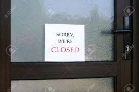 Sorry Were Closed Sign On The Front Door Of A Little Store