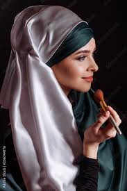beautiful muslim making makeup for