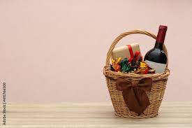wicker gift basket with food and wine