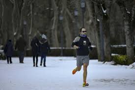 spain shovels out of snowdrifts left by