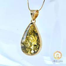 green amber pendant with inclusions