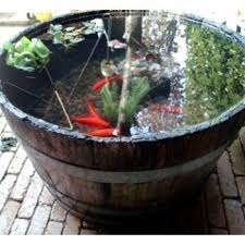 water feature from half whiskey barrels