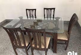 glass top dining table with 4 chairs in
