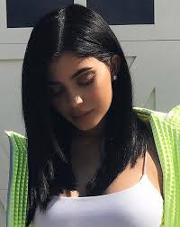 She keeps her short dark hair parted down the middle and slicked down behind each ear. 20 Kylie Jenner Hairstyles To Die For
