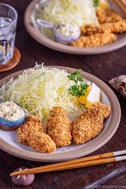 anese fried oysters kaki fry served with tartar sauce and shredded cabbage on the