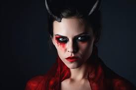 a woman with a devil face and red eyes