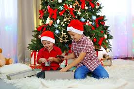 Happy father and cute little son in pajamas holding christmas gifts and smiling at camera. 130 Best Gift Ideas For Boys 2021 Baby To Teens