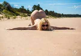 Young Nude Woman Posing On A Sandy Beach. Sexy Blonde Woman Enjoying Hot  Summer Day Outdoors Stock Photo, Picture and Royalty Free Image. Image  138802622.