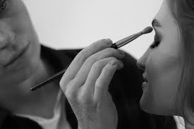 makeup artist applying eyeshadow on