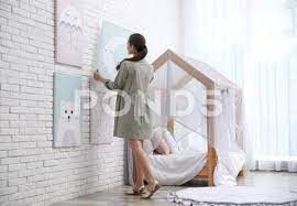 Decorator Hanging Picture On White