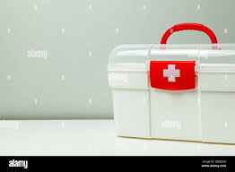 First Aid Kit White box with a cross and a red clasp on a gray